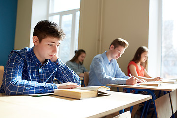 Image showing group of students with books writing school test