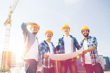 Image showing group of builders with tablet pc and blueprint