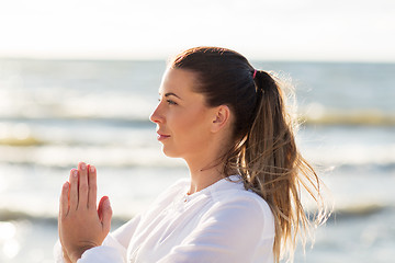 Image showing woman making yoga on summer beach