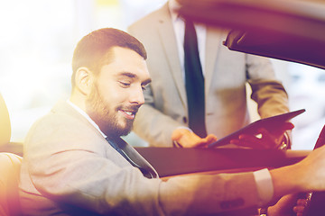 Image showing happy man with car dealer in auto show or salon