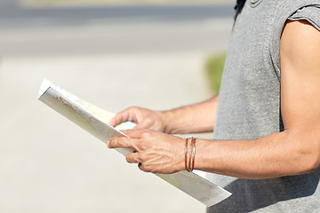 Image showing close up of man with travel map in city