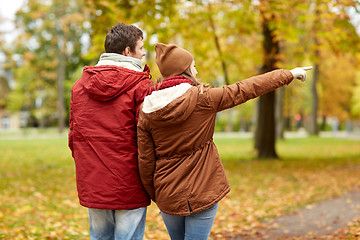 Image showing happy young couple walking in autumn park