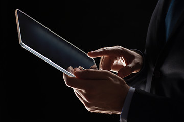 Image showing close up of businessman with transparent tablet pc