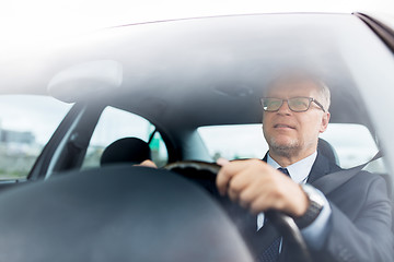 Image showing happy senior businessman driving car