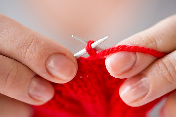 Image showing close up of hands knitting with needles and yarn