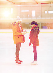 Image showing happy couple with engagement ring on skating rink