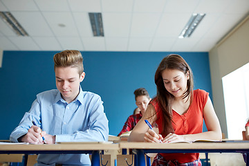 Image showing group of students with books writing school test