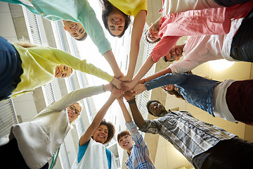 Image showing group of international students with hands on top