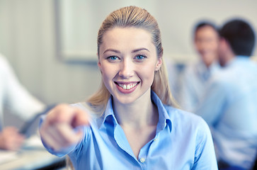 Image showing smiling businesswoman pointing finger on you