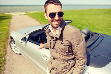 Image showing happy man near cabriolet car outdoors