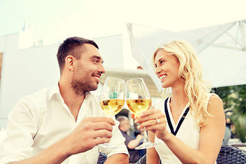 Image showing happy couple drinking wine at open-air restaurant