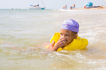 Image showing The girl choked and hit the water in the nose, while she was bathing in the sea