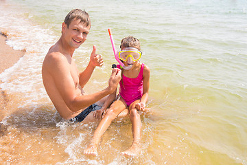 Image showing Dad and daughter are considering seven years found underwater shell