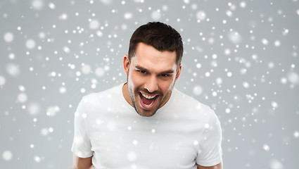 Image showing angry man shouting over snow background