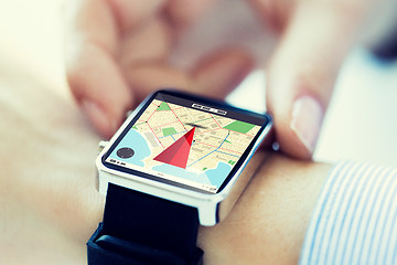 Image showing close up of hands with map on smartwatch screen