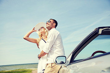 Image showing happy couple hugging near cabriolet car at sea