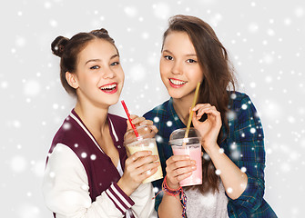 Image showing happy pretty teenage girls drinking milk shakes