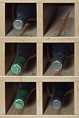Image showing Cells with five  wine bottles