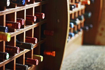 Image showing Wooden cells with wine bottles