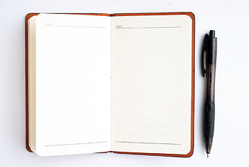 Image showing notepad with pen isolated