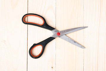 Image showing Scissors on wooden background