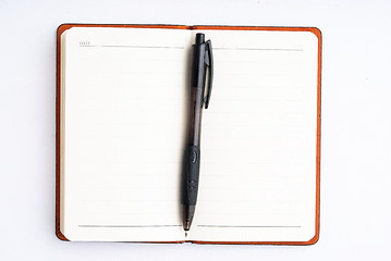 Image showing notepad with pen isolated