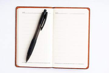 Image showing notepad with pen isolated