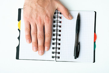 Image showing Hand on empty notepad