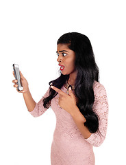 Image showing Angry woman looking at phone.