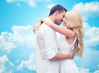 Image showing happy couple hugging over blue sky