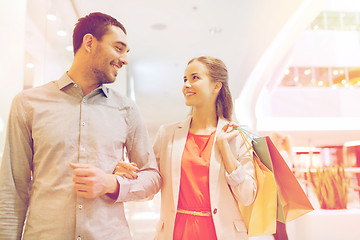 Image showing happy young couple with shopping bags in mall