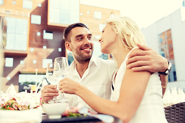 Image showing happy couple drinking wine at open-air restaurant