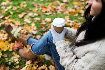 Image showing close up of  woman drinking coffee in autumn park