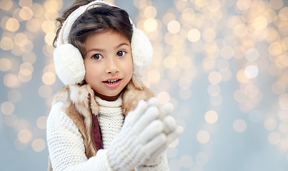 Image showing happy little girl wearing earmuffs