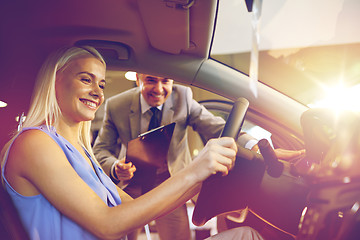 Image showing happy woman with car dealer in auto show or salon