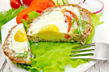 Image showing Tartlet meat with egg cut on light board