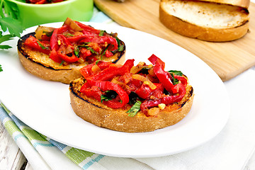 Image showing Bruschetta with tomatoes and peppers in plate on board