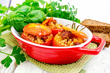 Image showing Tomatoes stuffed with bulgur in pan on light board