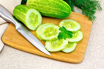 Image showing Cucumber with parsley on granite table