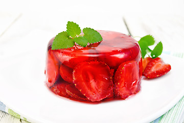 Image showing Jelly strawberry with mint in plate on board