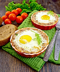 Image showing Tartlet meat with egg in pan on dark board