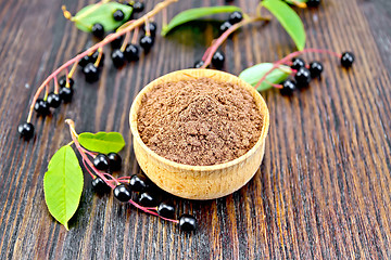 Image showing Flour bird cherry in bowl with berries and leaves on board