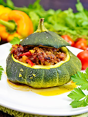 Image showing Squash green stuffed with meat and vegetables on board