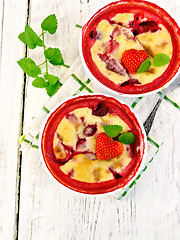 Image showing Pudding strawberry in two bowls on board top