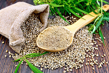 Image showing Flour hemp in spoon with bag and grains on board