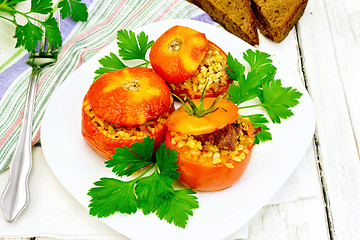 Image showing Tomatoes stuffed with bulgur and parsley in plate on table