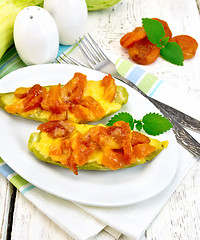 Image showing Courgettes in spicy sauce with dried apricots on light board