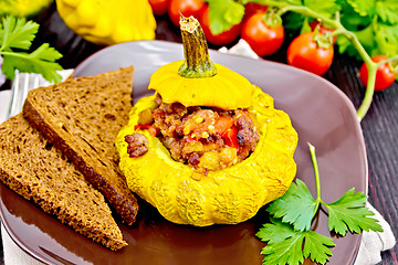 Image showing Squash yellow stuffed with meat and vegetables on board