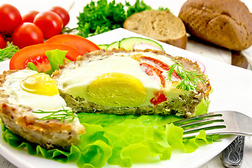 Image showing Tartlet meat with egg cut and vegetables on board