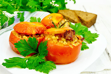 Image showing Tomatoes stuffed with bulgur and parsley in plate on board